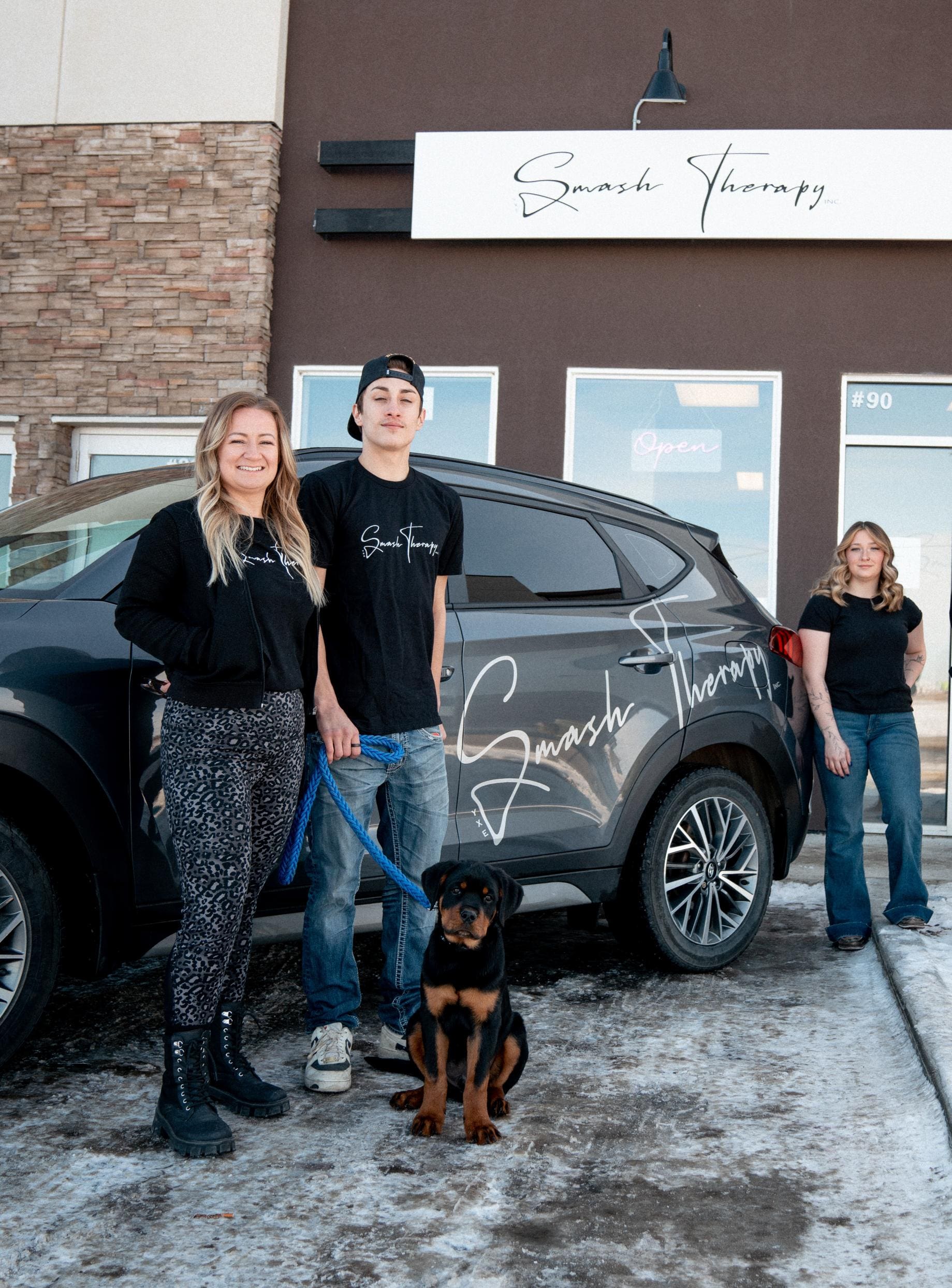 Smash Therapy team in front of building and branded vehicle