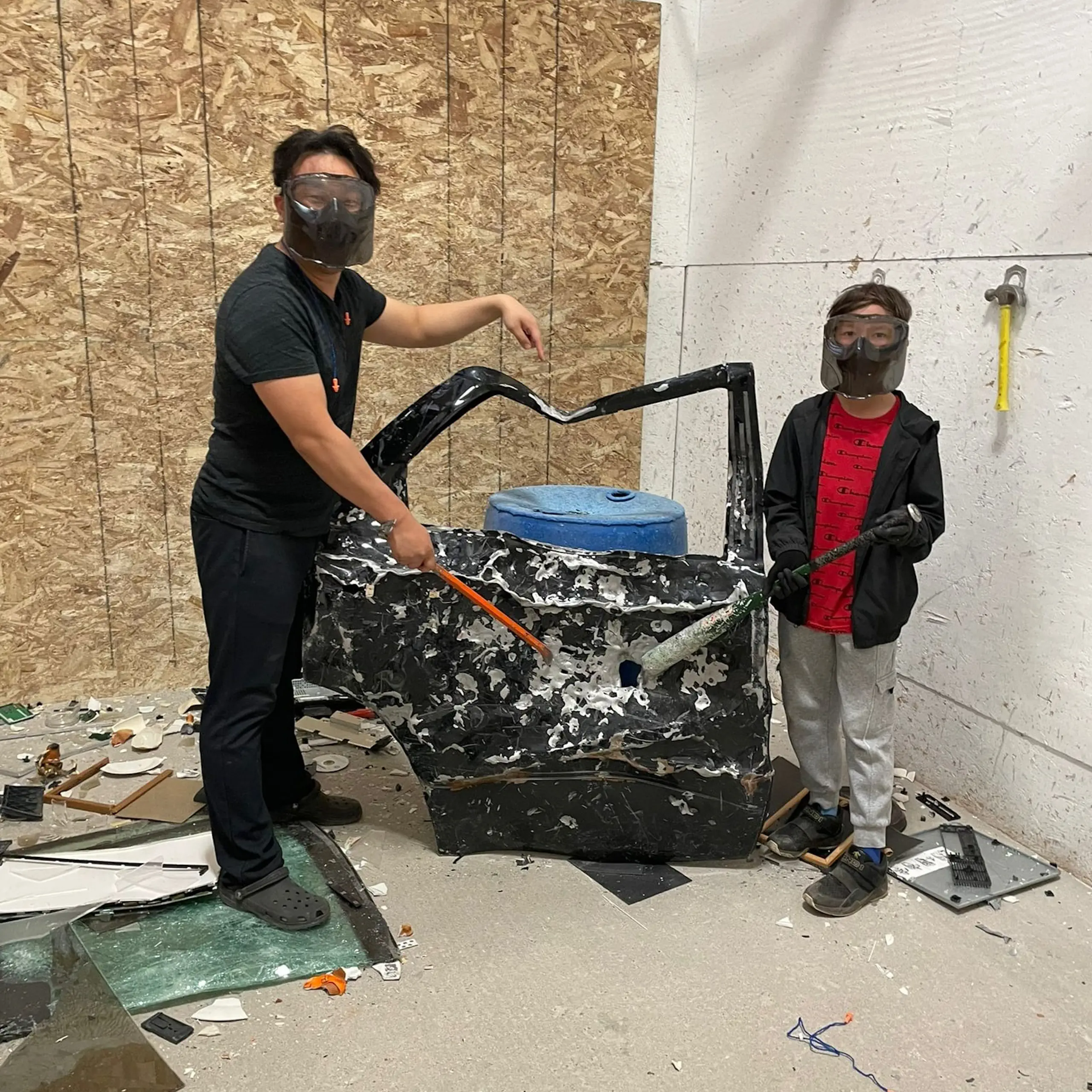 two people in a smash therapy room with a beat in car door